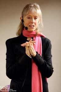 Sally Kempton speaking in a pink scarf